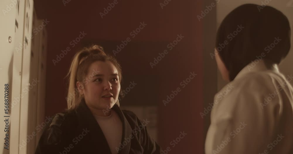 Female fighters getting dressed and talking Female fighters getting dressed and talking