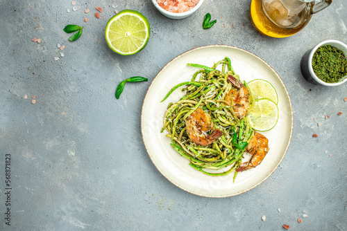 zucchini spaghetti Pasta with basil pesto sauce and grilled shrimp, Vegetarian healthy food, place for text, top view