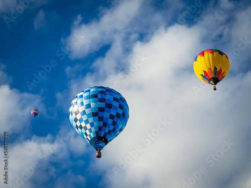 Low angle view of three hot air balloons against clouds and sky, Mass Ascension, Albuquerque International Balloon Fiesta, New Mexico