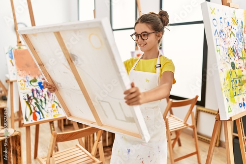 Adorable girl smiling confident looking canvas draw at art studio
