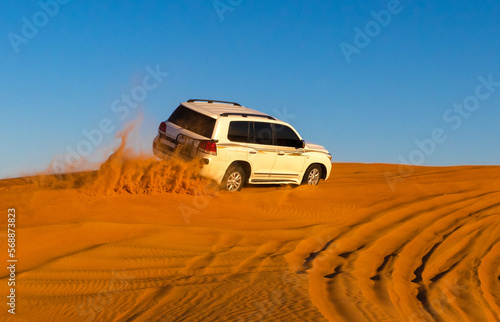 Offroad safari in sand desert, Empty Quarter Desert in United Arab Emirates. Offroader on dunes in Rub’ al Khali desert. Sand and sky. © Sergo