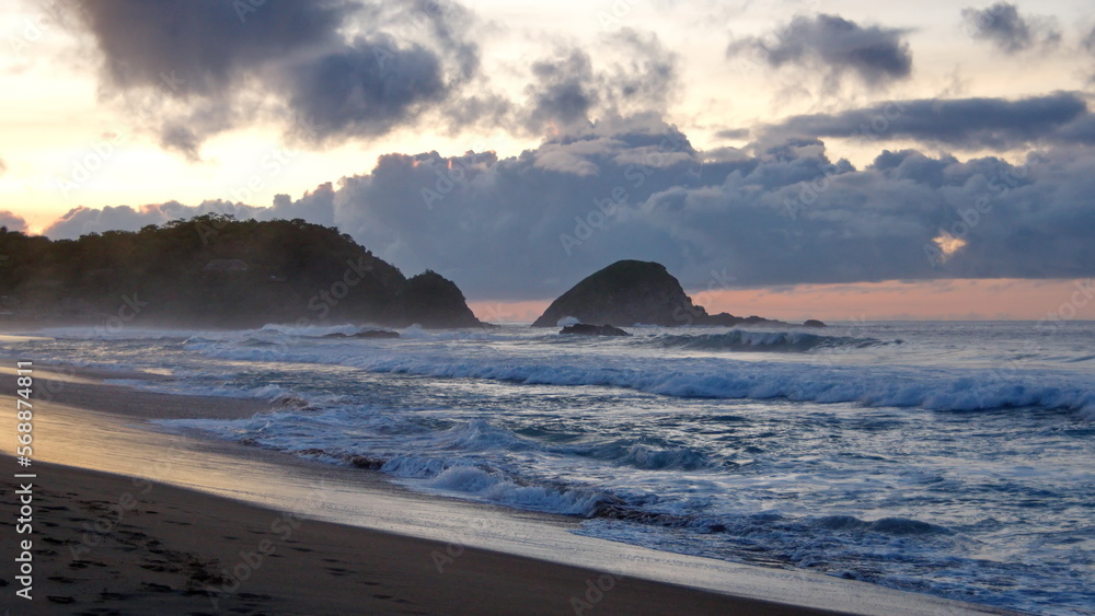Silhouette of an islet just off the beach in Zipolite, Mexico Silhouette of an islet just off the beach in Zipolite, Mexico