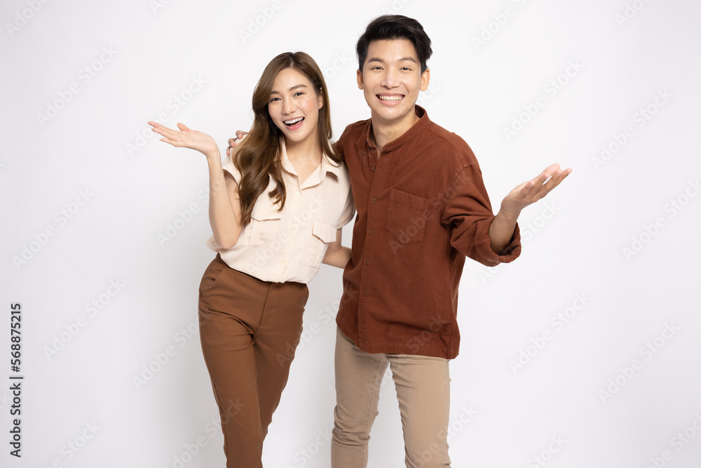 Happy Asian couple presenting or showing open hand palm with copy space for product isolated over white background Happy Asian couple presenting or showing open hand palm with copy space for product isolated over white background