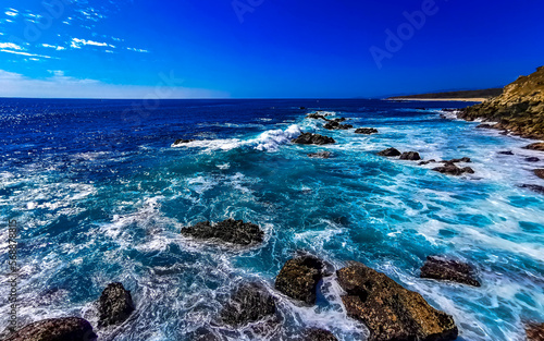 Beautiful rocks cliffs view waves at beach Puerto Escondido Mexico. photo