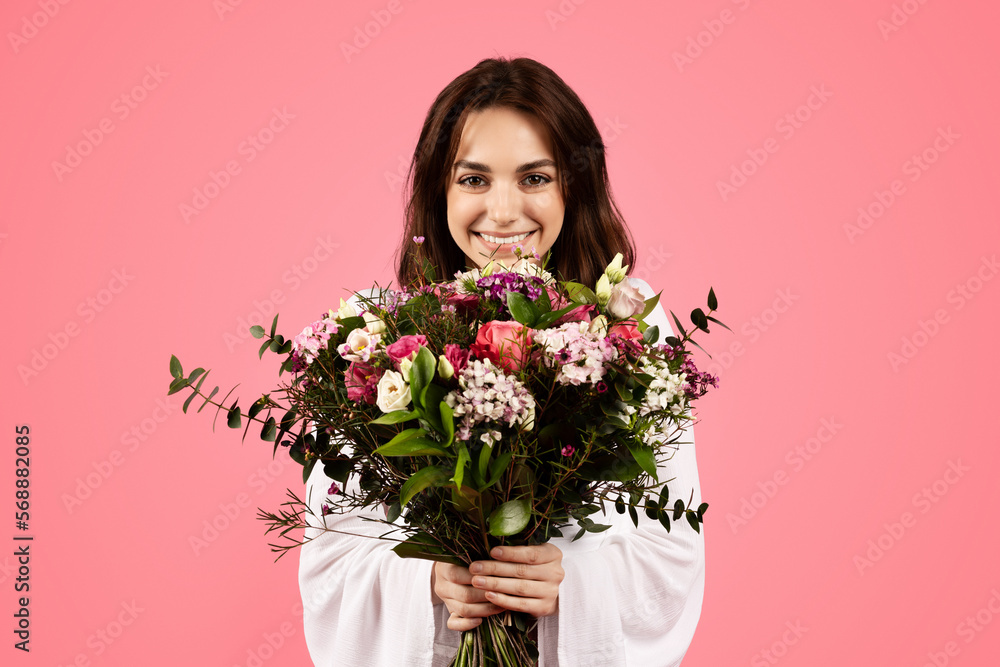 Cheerful pretty young european lady enjoy gift, bouquet of white tulips, spring holiday Cheerful pretty young european lady enjoy gift, bouquet of white tulips, spring holiday