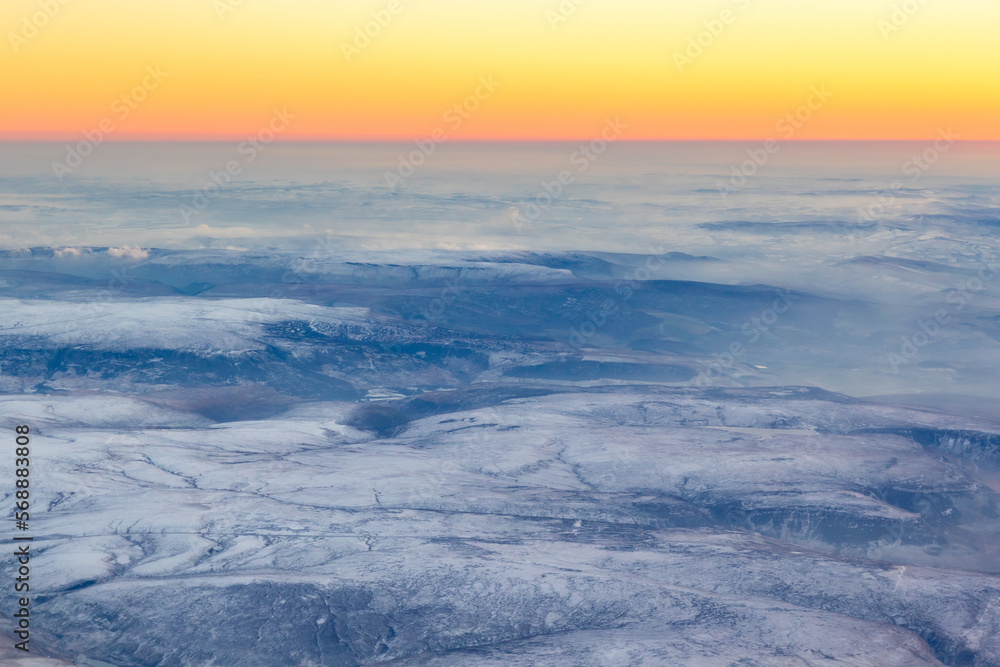 Obraz premium Aerial view of the Peak District, during sunset in winter with snow
