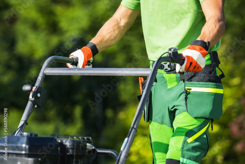 Landscaper Using Lawn Aerating Equipment photo