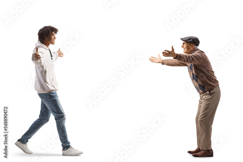 African american young man walking towards an elderly man with arms wide open