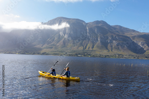 South Africa, Stanford, Boy and teenage girl (10-11, 16-17) kayaking in lagoon photo