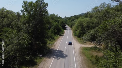 BLUE CAR DRIVES THROUGH THE FORESTS PERFECT ROUTE