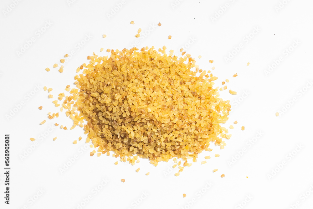 Pile of bulgur raw grain isolated at white background. Organic healthy vegetarian food Pile of bulgur raw grain isolated at white background. Organic healthy vegetarian food