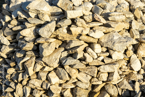 Gravel texture. Pebble stone background. Light grey and cream closeup small rocks. Top view of ground gravel.