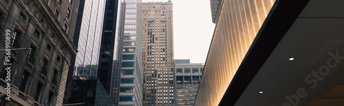 Photography modern buildings and illuminated entrance in Manhattan district of New York City, banner