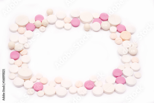 frame of pink and white pills on a white isolated background. background of pills © spoilergen