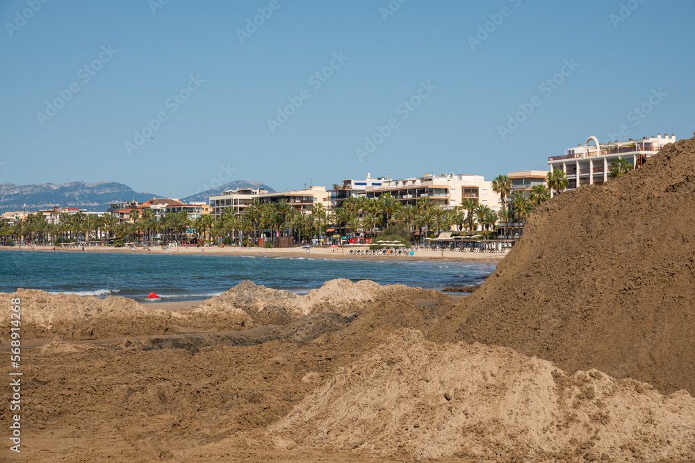 Fototapeta premium A mountain of wet sand at a construction site on the beach.