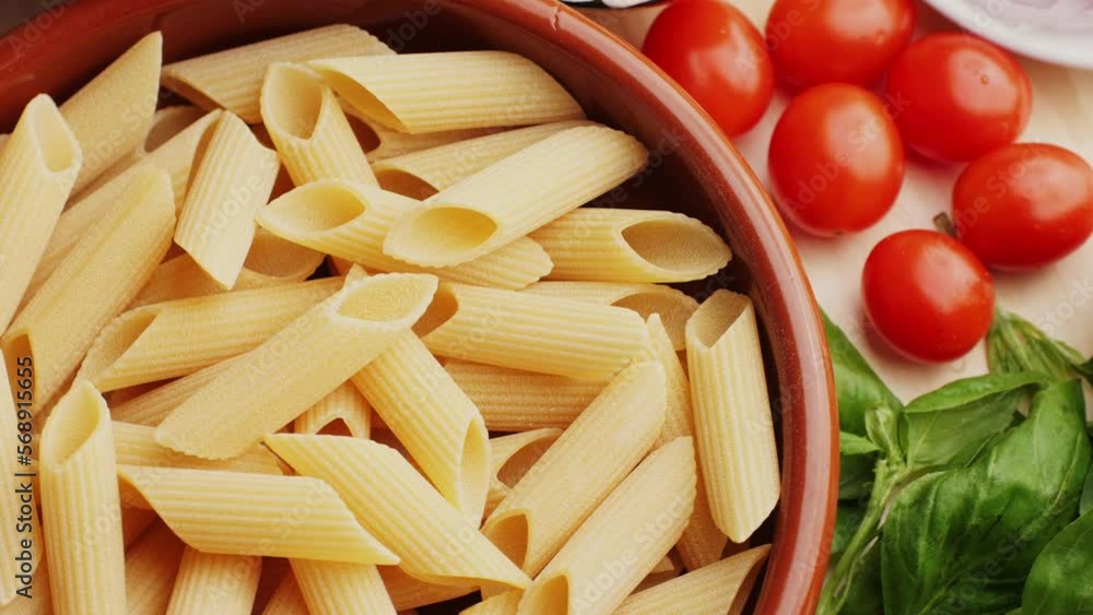 Colorful pattern of italian pasta, tomatoes, sauce, penne pasta ingredients, olive oil spices and basil, Top view Food concept. Colorful pattern of italian pasta, tomatoes, sauce, penne pasta ingredients, olive oil spices and basil, Top view Food concept.