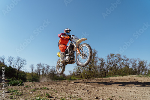 Fototapeta Naklejka Na Ścianę i Meble -  Man riding motorbike on motocross track.Extreme and Adrenaline. Motocross rider in action. Motocross sport. Active lifestyle