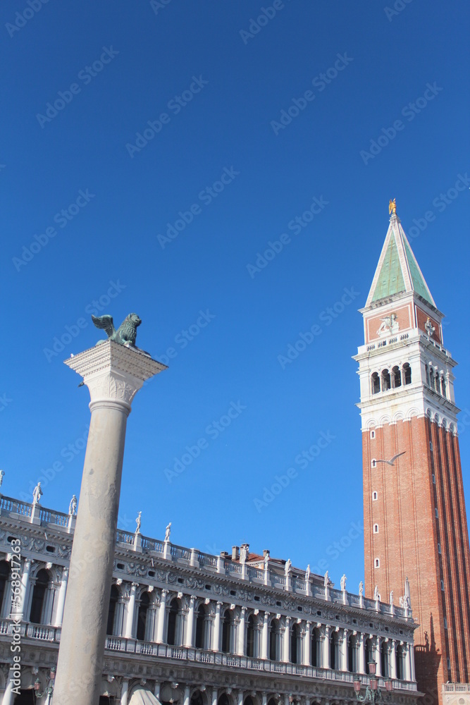 Venice beaches, gondolas, churches, St. Mark's City Square, the tower in the square, the church, the medieval and Roman artifacts, the canals in the city, the gondolas going on the canals and the sea,