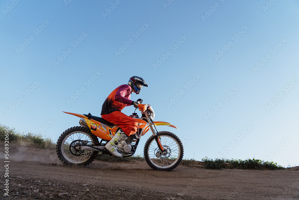Man riding motorbike on motocross track.Extreme and Adrenaline. Motocross rider in action. Motocross sport. Active lifestyle Man riding motorbike on motocross track.Extreme and Adrenaline. Motocross rider in action. Motocross sport. Active lifestyle
