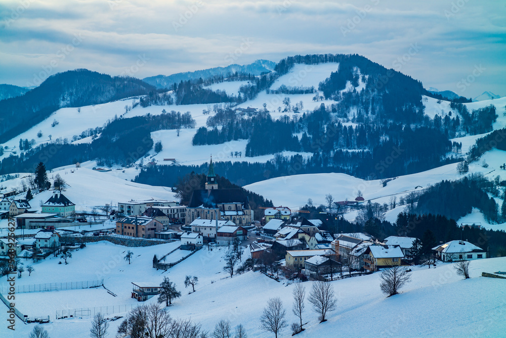 mountain landscape near the village of maria neustif in upper austria on an evening in winter