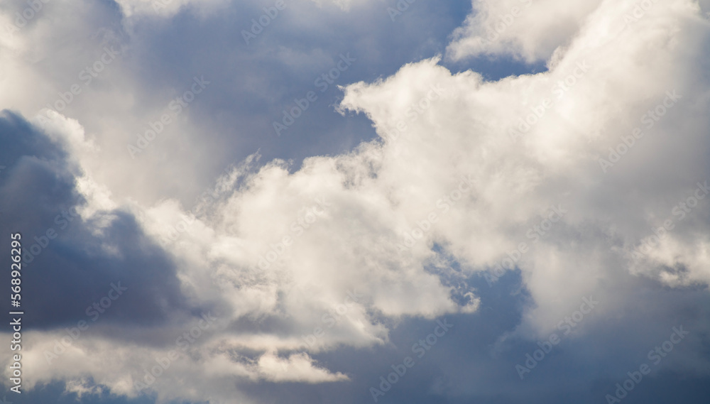 Beautiful huge fluffy clouds on the blue sky. Sky clouds background. Beautiful huge fluffy clouds on the blue sky. Sky clouds background.
