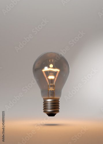 Classical style lightbulb E27. Hovering over studio floor. Burning softly. Idea metaphor. Glowing thread. Bright room.