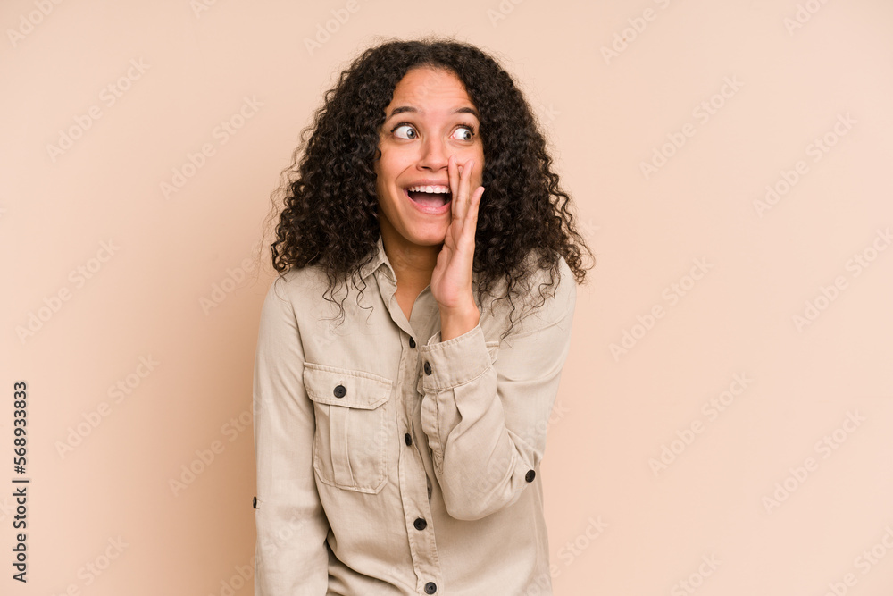 Young african american curly woman isolated shouting excited to front.