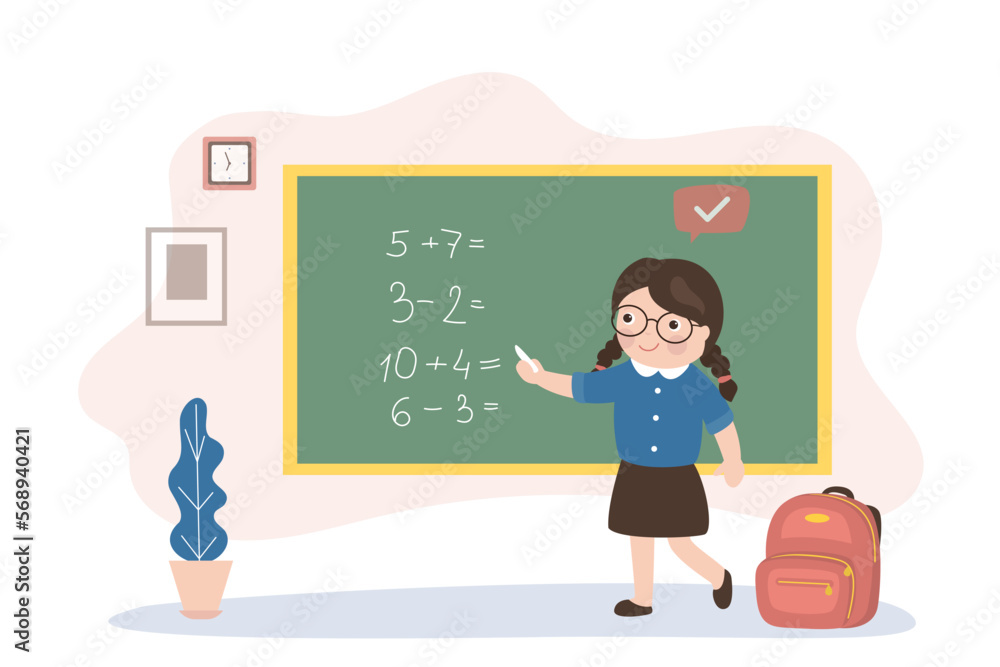 Cute schoolgirl stands at the blackboard and solves mathematical ...