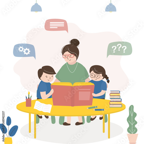 Teacher reads book to students. Kindergarten teacher studying textbook with small kids. Educational process, people sit at table and read. Family, mother spends time with children.
