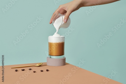 coffee in clear glass with milk foam by Barista