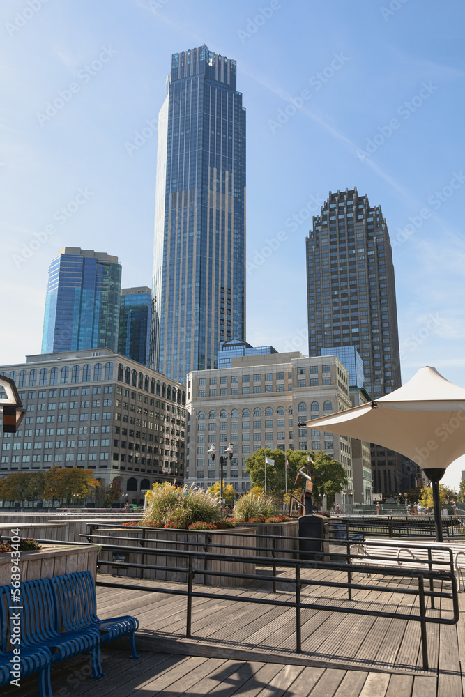 Obraz premium modern skyscrapers near embankment walkway in New York City.