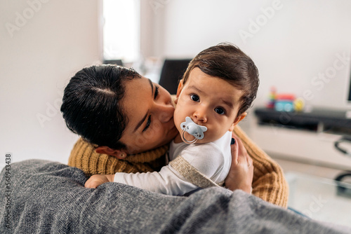 Mother Kissing her Baby at Home