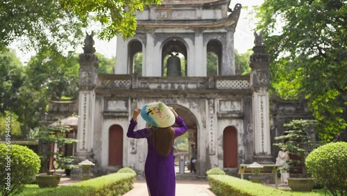 Portrait of Asian Vietnamese woman girl in local temple traveling in Hanoi urban city town, Vietnam. People lifestyle.