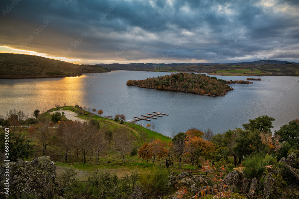 Wonderful sunset in Tras Os Montes, northern Portugal. Amazing landscape of Albufeira do Azibo. A huge lake with river beach and dock for pleasure boats. Postcard with panoramic view in the background