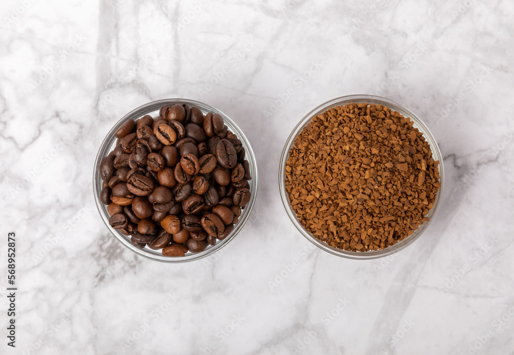 Coffee granules and coffee beans on a white marble background. Instant coffee drink. Energy hot drink. Place for text. Place for copy. Cheerful morning concept. Coffee granules and coffee beans on a white marble background. Instant coffee drink. Energy hot drink. Place for text. Place for copy. Cheerful morning concept.