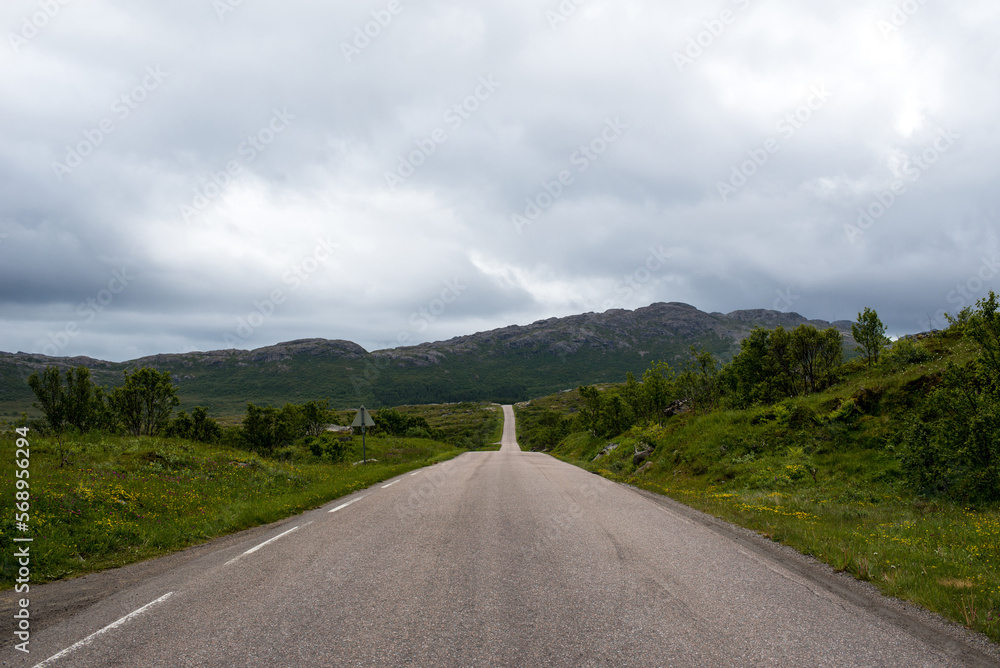 Scenic road along the fjords in Norway. Amazing landscape. Northern nature. Snow-capped mountains. Dramatic clouds. Travel, adventure Scenic road along the fjords in Norway. Amazing landscape. Northern nature. Snow-capped mountains. Dramatic clouds. Travel, adventure