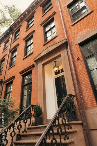 low angle view of brick house with lantern above entrance in Brooklyn Heights district of New York City.
