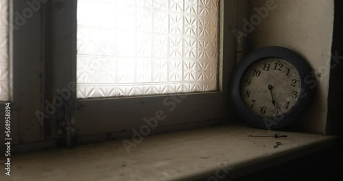 Old and vintage blank clock dial without hand on old wooden windowsill. Studio shot