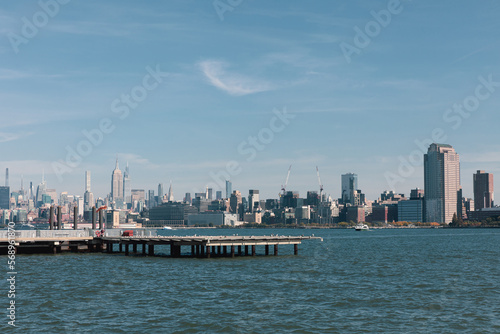 picturesque view of New York bay with pier and skyscrapers of Manhattan.