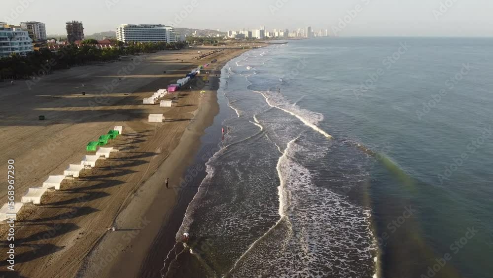Panoramic drone view of the coast, the people, the beach and the ocean at sunrise Panoramic drone view of the coast, the people, the beach and the ocean at sunrise