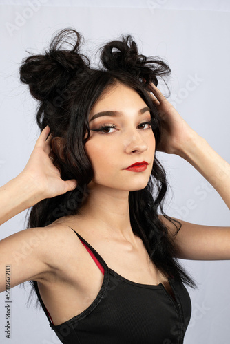 model with black hair with half up down space buns hairstyle style rave event fun fashion beauty caucasian light complexion alternative modeling nose ring red lipstick bun creative