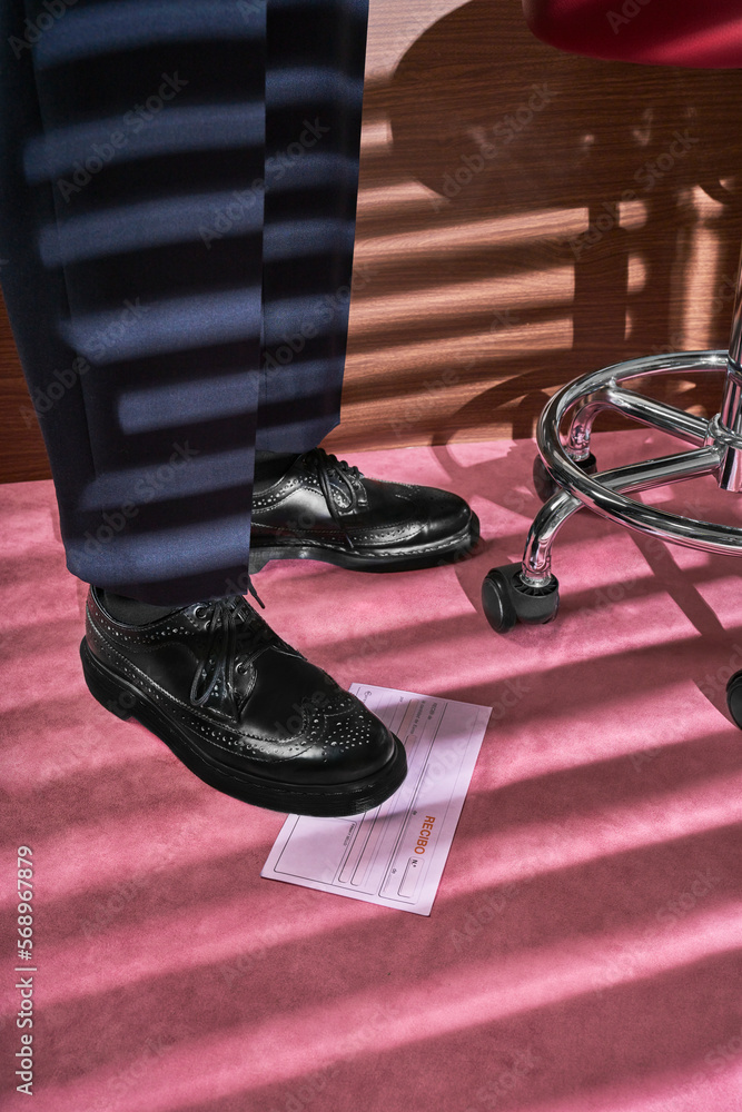 Business man stepping on receipt Business man stepping on receipt