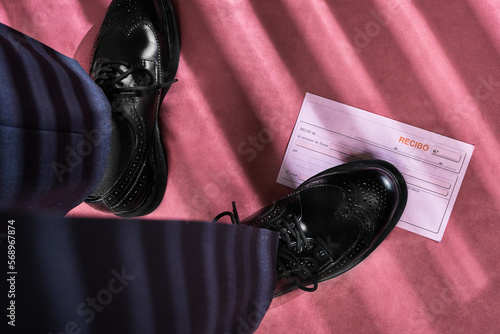 Business man stepping on receipt