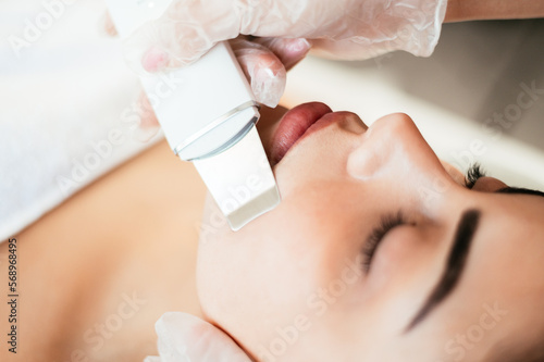 Cosmetologist giving facial cleaning to client
