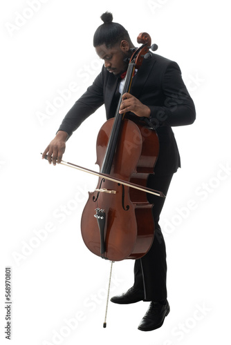 Full length portrait of a african american musician in a black suit and bow-tie playing a cello isolated on white background