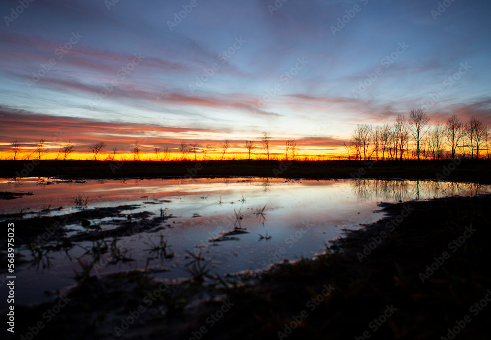 water pond in sunset orange and blue sky 