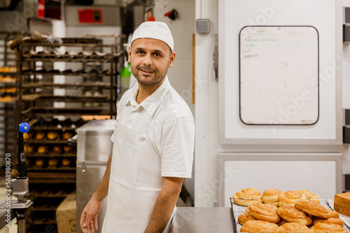 Male baker in restaurant kitchen photo