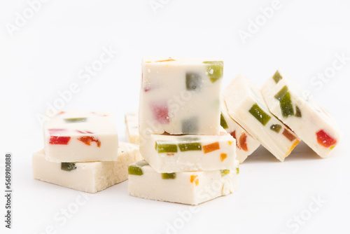 Indian Mithai Milkybar Vanilla Ice Cream Burfi, Barfi, Burfee Or Barfee Made Of Milk Powder Mixed With Sugar Syurp, Dry Fruits And With Fruit Jam Drops Top Is As Soft And Melting As Icecream photo