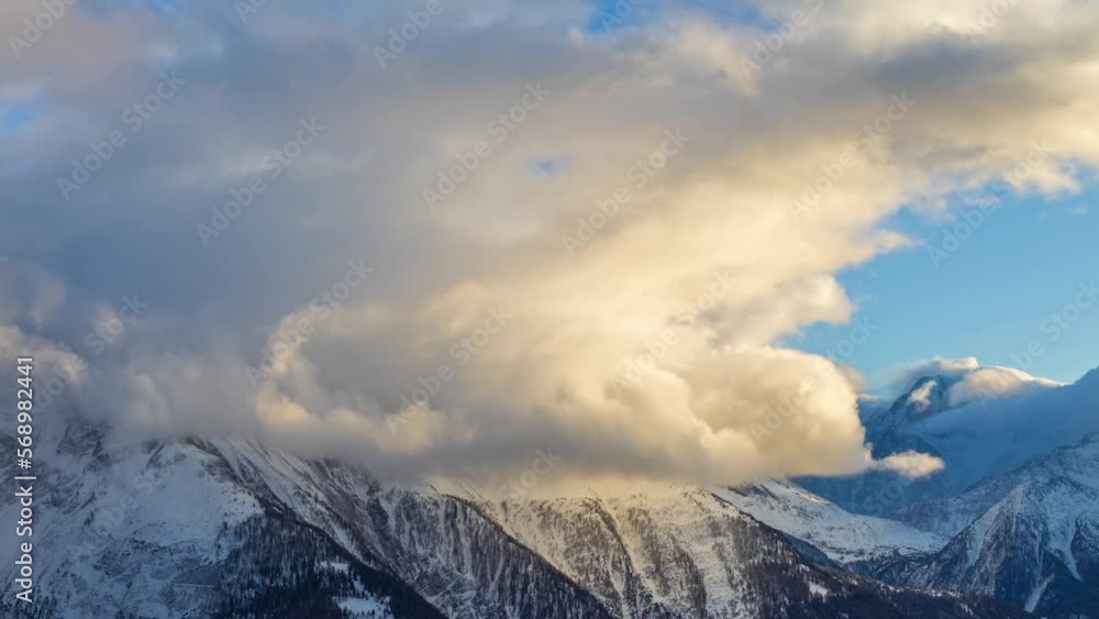 Time lapse, fluffy clouds above the mountains at sunset. View from Bettmeralp. Canton of Valais. Switzerland. Time lapse, fluffy clouds above the mountains at sunset. View from Bettmeralp. Canton of Valais. Switzerland.
