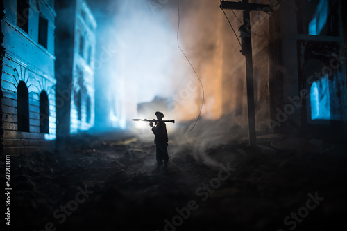 Military soldier silhouette with bazooka. War Concept. Military silhouettes fighting scene on war fog sky background, Soldier Silhouette aiming to the target at night. Attack scene